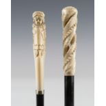 An Edwardian ebonized walking cane, the ivory handle carved as a Kate Greenaway style girl, length
