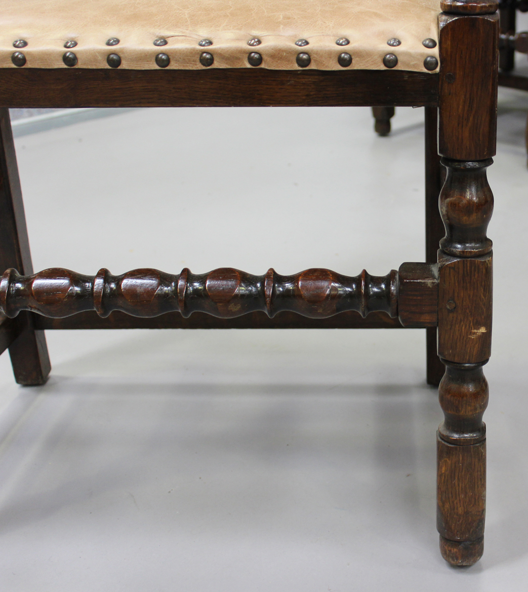 A set of eight Jacobean Revival oak dining chairs with light brown leather seats and backs, - Image 4 of 6