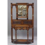 A late Victorian oak hallstand with carved foliate decoration, fitted with a drawer, on turned