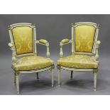 A pair of 20th century Louis XVI style white painted and gilt fauteuil armchairs, upholstered in