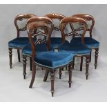 A set of six Victorian mahogany balloon back dining chairs, the overstuffed seats on turned legs,