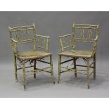 A pair of Regency painted ash faux bamboo elbow chairs with woven rush seats, retaining much of