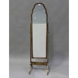An early 20th century Queen Anne style walnut framed cheval mirror, height 151cm, width 40cm.Buyer’s