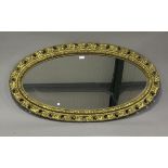 An early 20th century gilt painted, carved and moulded oval wall mirror, 121cm x 65cm.Buyer’s