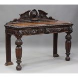 A late Victorian oak hall table, profusely carved with masks and rosettes, fitted with two