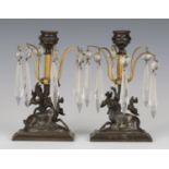 A pair of 19th century brown patinated cast bronze table lustre candlesticks, each stem with six