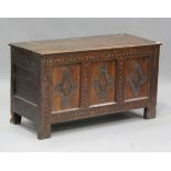 An early 18th century oak coffer with inlaid borders, the hinged lid above a triple panel front with