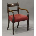 A Regency mahogany bar back elbow chair with carved back and red velour padded seat, height 82cm,