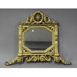 A 19th century Continental giltwood wall mirror with a star and wreath surmount above an octagonal