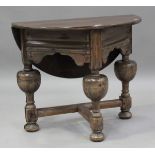 A 20th century Continental stained pine credence table, the drop-flap top raised on turned and block