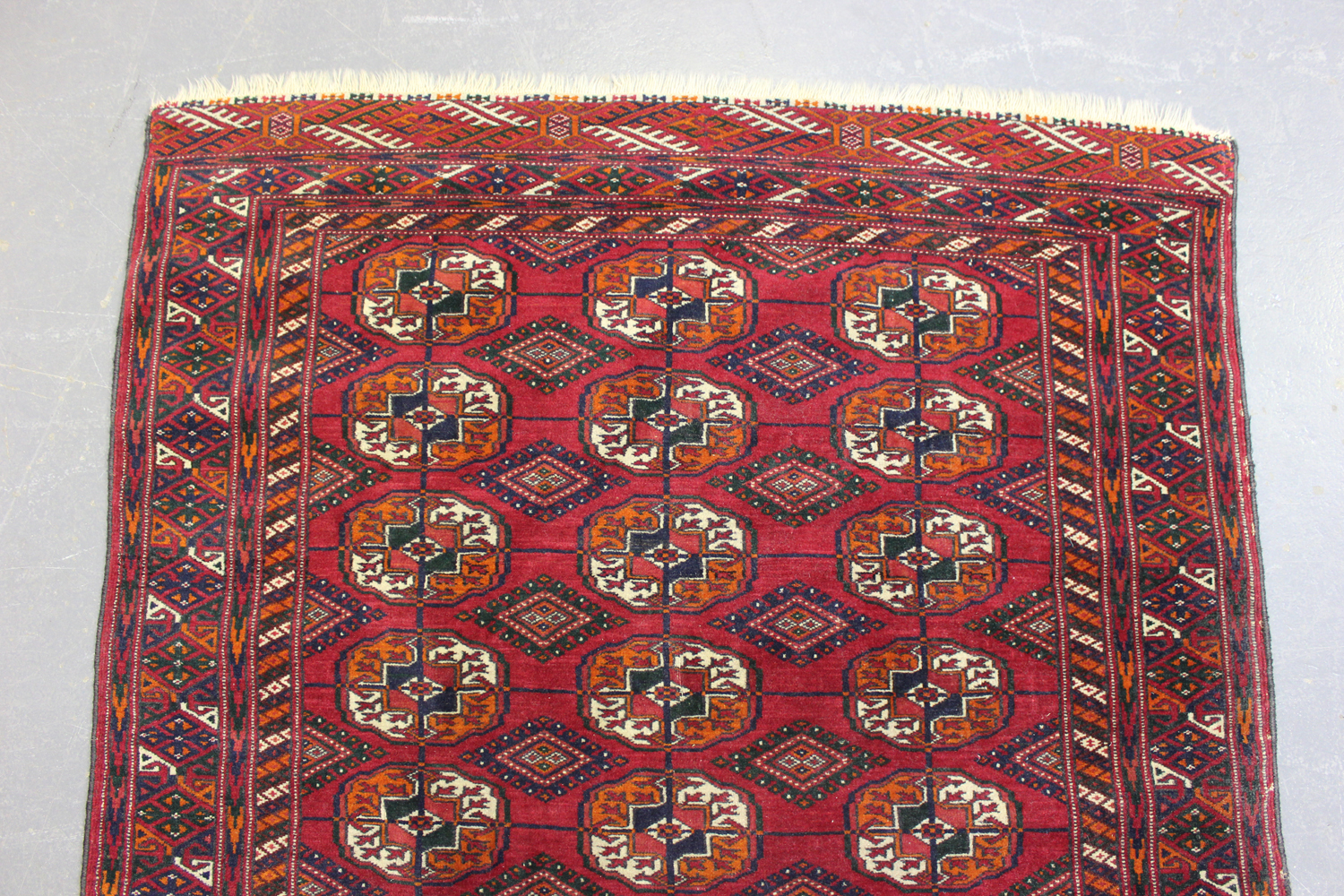 A Tekke rug, West Turkestan, mid-20th century, the claret field with three columns of guls, within a - Image 3 of 4