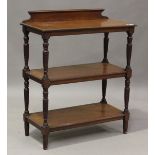 A late Victorian walnut three-tier serving buffet by James Shoolbred & Co, raised on spiral reeded