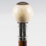 An early 20th century hardwood walking cane with spherical ivory handle and silver collar, London