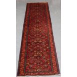 A Malayer runner, North-west Persia, early/mid-20th century, the red field with overall herati,