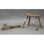 A 19th century sycamore hearth stool of primitive form, fitted with four staked legs, height 40cm,