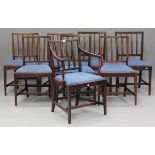 A set of eight George III mahogany rail back dining chairs, comprising one elbow and seven