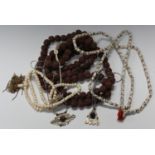 An ethnic necklace formed from nuts, two bone necklaces and two nickel pendants.Buyer’s Premium 29.