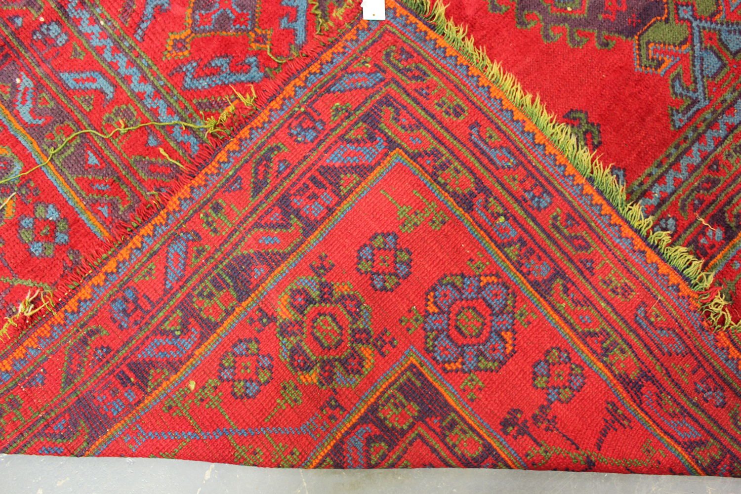 A large Turkish 'Old Turkey' carpet, early 20th century, the red field with overall palmettes and - Image 11 of 11