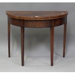 A George III figured mahogany demi-lune fold-over card table, crossbanded in satinwood, on square
