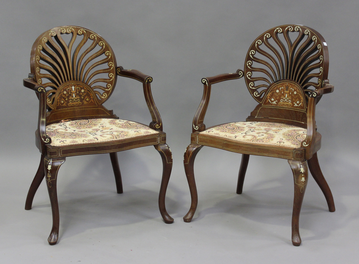 A pair of Edwardian Neoclassical Revival mahogany pierced fan back salon chairs with profusely