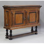 A 19th century Continental walnut side cabinet-on-stand, fitted with a pair of panel doors with