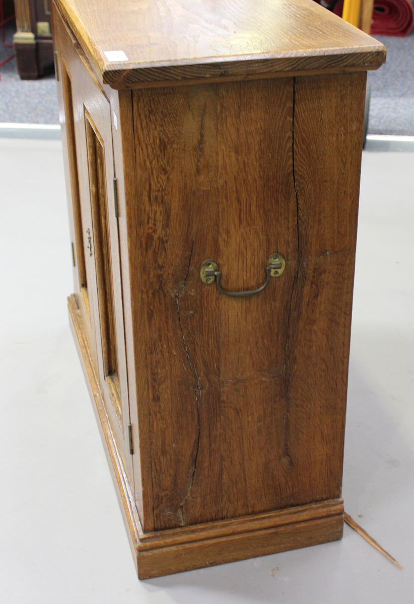 A late 20th century pale oak two-door side cabinet, fitted with carrying handles, on a plinth - Image 2 of 4