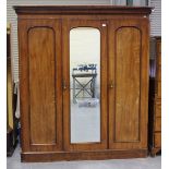 A late Victorian mahogany three-section wardrobe, fitted with panelled doors, height 215cm, width