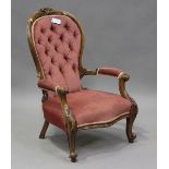A late Victorian walnut showframe salon armchair, upholstered in pink velour, on cabriole legs,