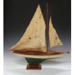 An early 20th century painted wooden pond yacht with weighted keel and cloth sails, length 82cm,