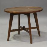 A mid-20th century teak circular occasional table of retro design, the planked top with raised edge,