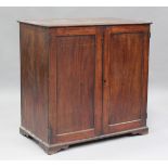 A 19th century mahogany side cabinet, the hinged top above a pair of panelled doors, on bracket