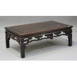 A late 20th century Chinese hardwood low table, the panelled rectangular top on block legs, height