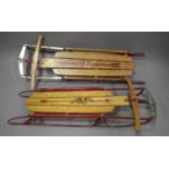 Two early/mid-20th century ash and painted metal framed 'Flexible Flyer' sleds, length 120cm.Buyer’s