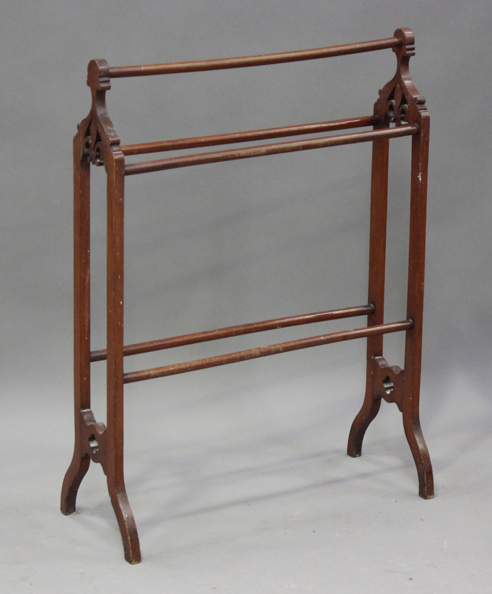 A late Victorian mahogany towel rail, each end fret cut with a fleur-de-lis, height 96cm, width