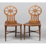 A pair of George III mahogany hall chairs, in the manner of Gillows of Lancaster, the pierced oval