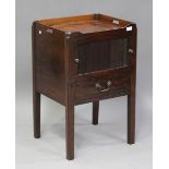 A George III mahogany night cupboard with pierced handles, the tambour front above a drawer, on
