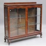 A George V mahogany display cabinet, on cabriole legs, height 120cm, width 123cm, depth 32cm.Buyer’s
