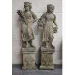 A near pair of late 20th century cast composition stone garden figures, raised on foliate