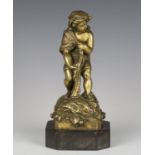 A late 19th century French cast gilt bronze figure of a young fisherboy, hauling in a net, raised on