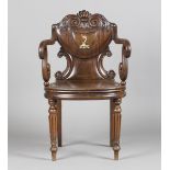 A William IV mahogany elbow hall chair, in the manner of Gillows of Lancaster, the shield back