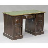 An Edwardian mahogany twin pedestal desk, the later top above a drawer and cupboards, height 74cm,