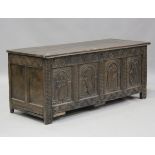 An 18th century oak coffer, the panelled front carved with a figure and three animals, height