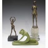 After Bruno Zach - a modern cast bronze figure of a semi-clad maiden, raised on a marble plinth,