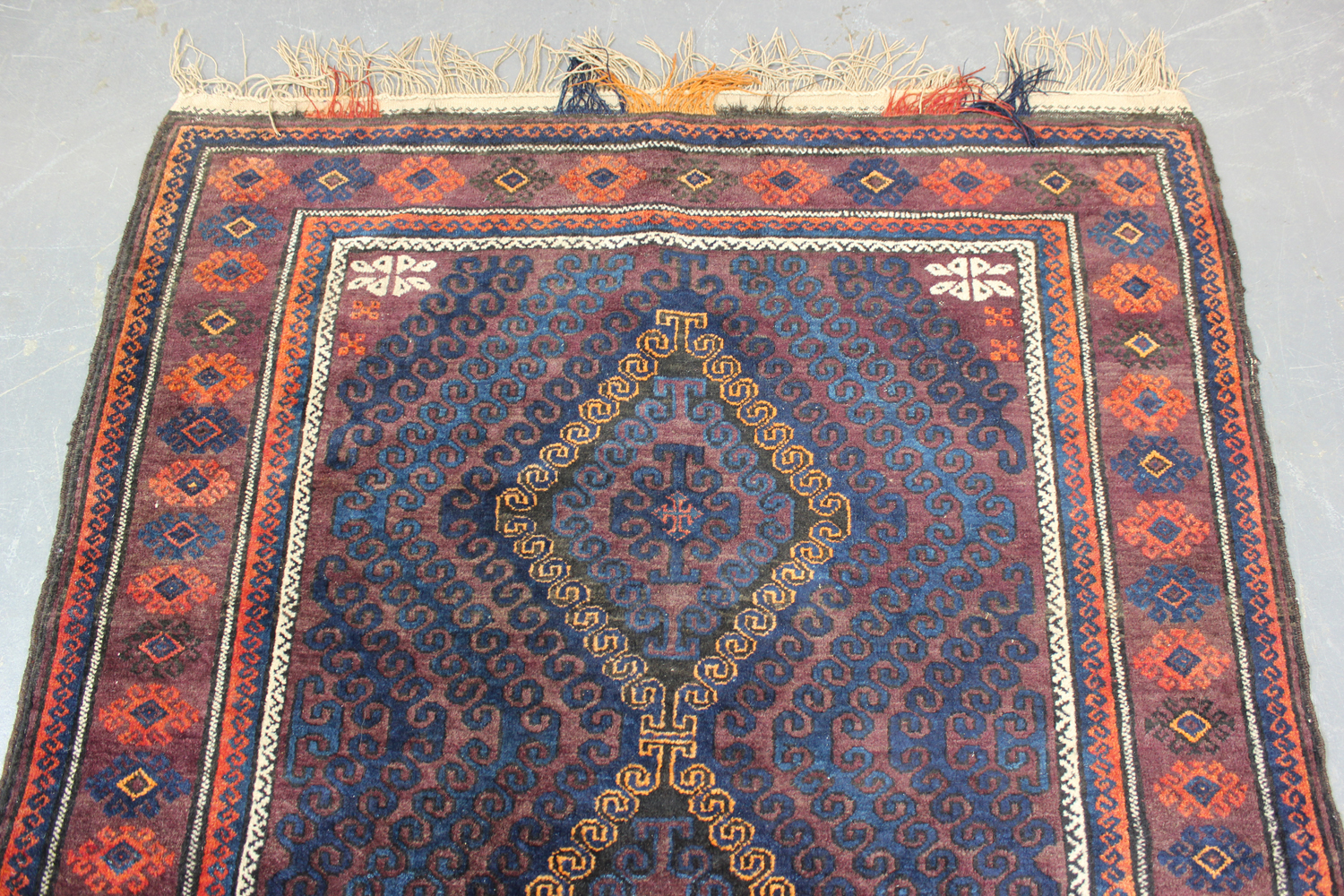 A Beluche rug, Afghan/Persian borders, mid-20th century, the aubergine field with three hooked - Image 2 of 4