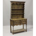 A 20th century Jacobean Revival oak narrow dresser, the shelf back above two drawers and an