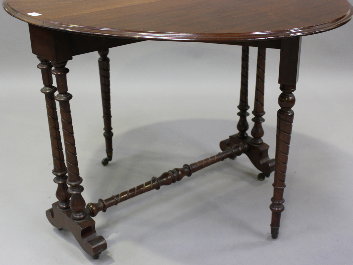 A late Victorian walnut oval Sutherland table, on spiral fluted legs and brass castors, height 73cm, - Image 2 of 4