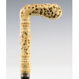 A 19th century ebonized walking cane, the Chinese Canton ivory handle carved and pierced with