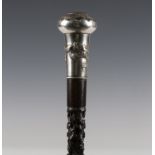 An early 20th century Chinese Canton carved ebony walking cane, the white metal handle finely worked
