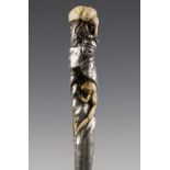 A late 19th century Japanese handled ebony walking cane, the silver and carved ivory handle finely