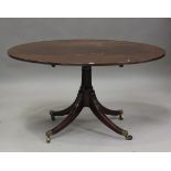 A George III mahogany oval tip-top breakfast table, on a turned column and reeded sabre legs, height